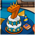 O Bolo, o Chapéu de Aniversário e o Livro do Ano da festa.